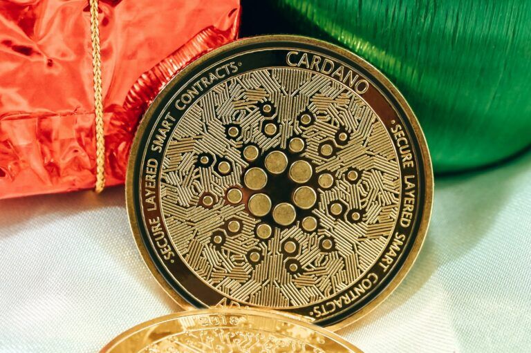 Cardano-coin-on-green-red-and-white-background-768x511