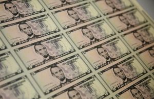 Dollar edges lower; euro hit by weak German factory orders