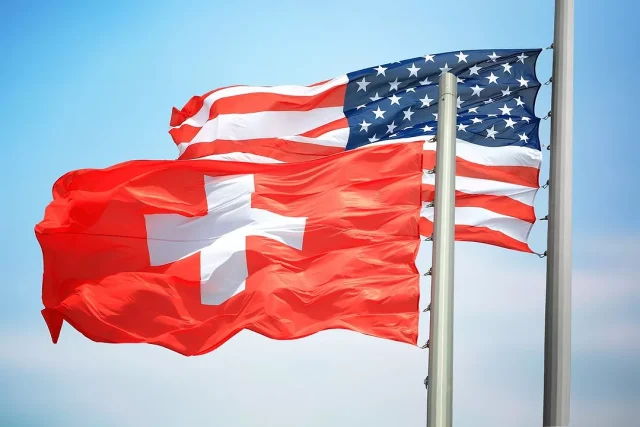 SWITZERLAND-US-FLAGS-iStock-3dmitry-1145463801
