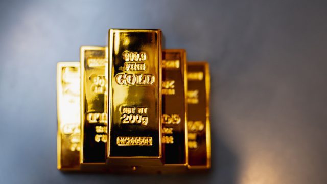 Gold bars rest on a company employee's desk, symbolizing the sound investment strategy of saving in gold.